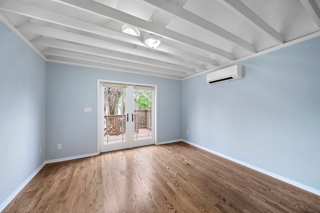 spare room featuring wood-type flooring, beam ceiling, and a wall mounted AC