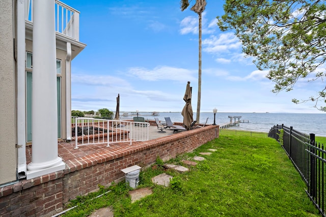 view of yard with a patio and a water view