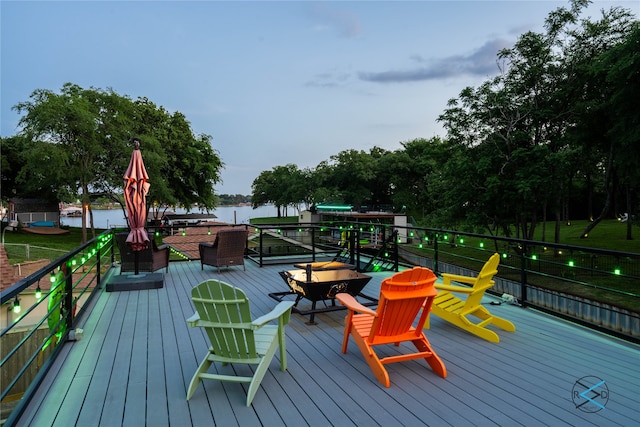 wooden terrace featuring a water view