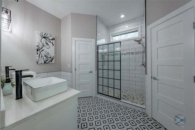 bathroom with tile flooring and a shower with door