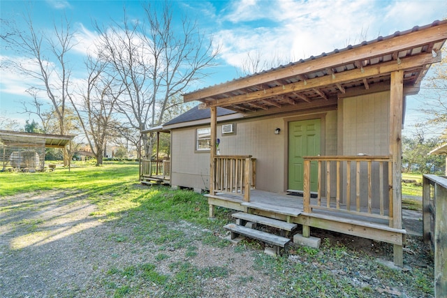 back of property featuring a deck and a yard