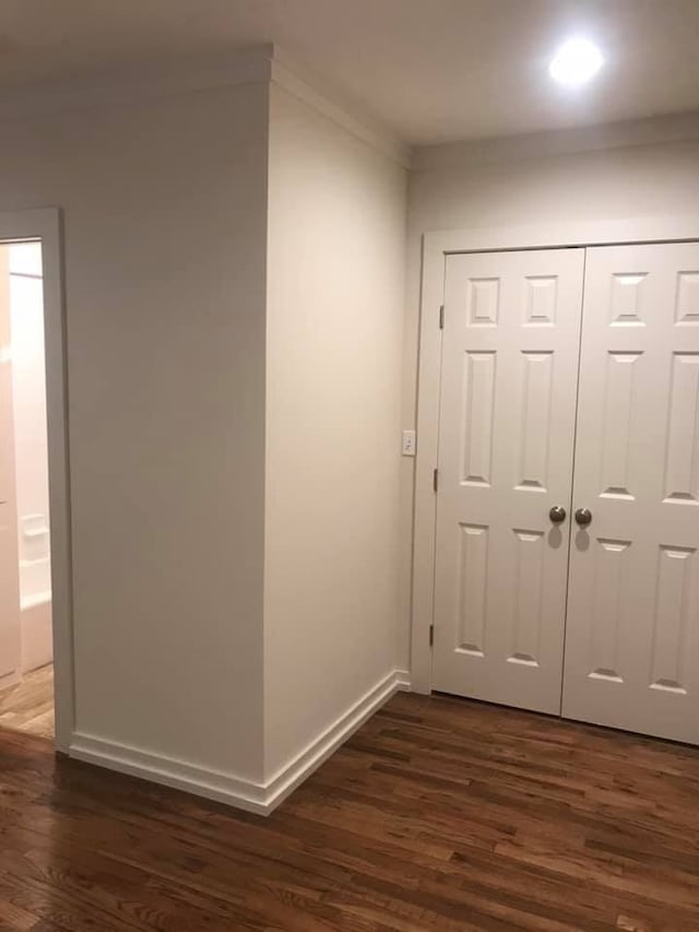 interior space featuring crown molding and dark hardwood / wood-style floors