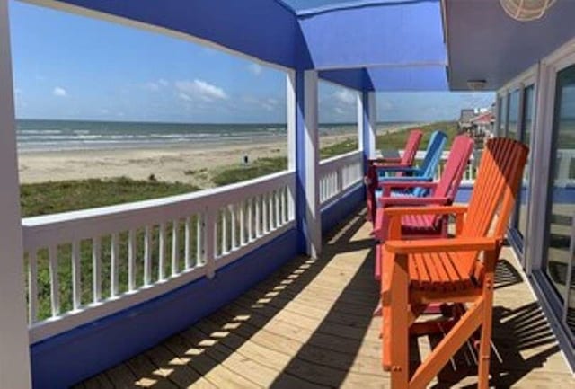 balcony featuring a water view and a view of the beach