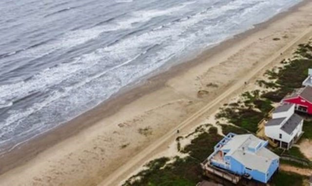 exterior space with a beach view and a water view