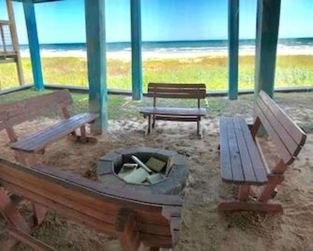 sunroom / solarium featuring a water view