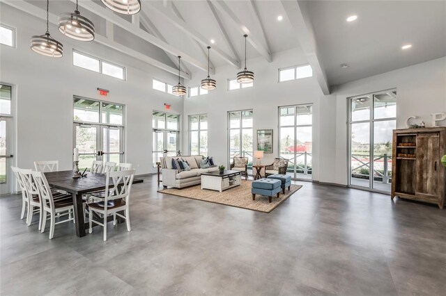 living room featuring beamed ceiling, a wealth of natural light, and high vaulted ceiling