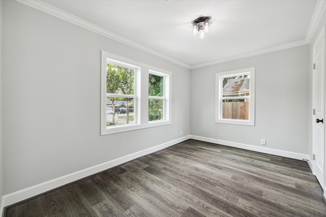 empty room featuring dark wood-type flooring and ornamental molding