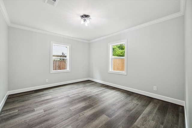 empty room with crown molding and dark hardwood / wood-style floors