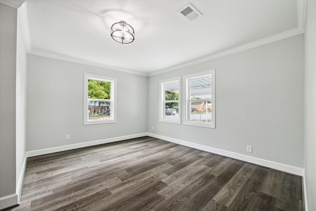 empty room with ornamental molding and dark hardwood / wood-style flooring