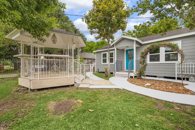 exterior space with a front yard and a wooden deck