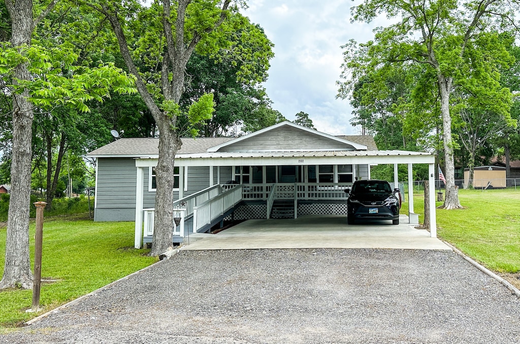 202 New Cove Dr, Livingston, TX 77351 - view of front of home with a carport and a front yard