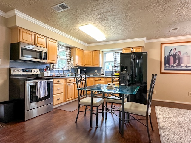 kitchen featuring appliances with stainless steel finishes, dark hardwood / wood-style floors, crown molding, and a textured ceiling