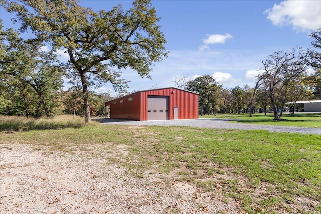 view of shed / structure featuring a garage and a yard