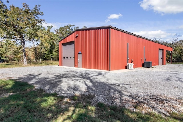 view of shed / structure featuring a garage and central AC unit