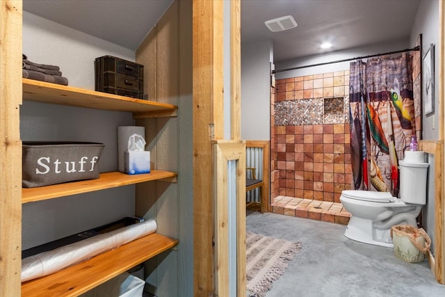 bathroom featuring toilet and concrete floors