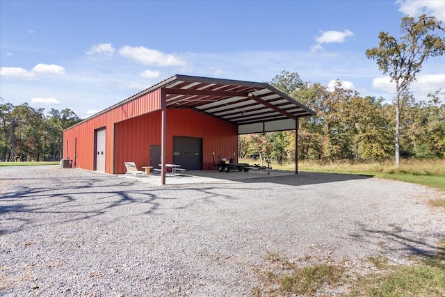 view of outdoor structure with a carport and a garage