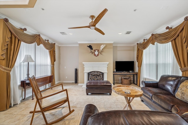 living room featuring ceiling fan, light tile floors, and ornamental molding