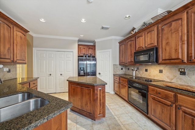 kitchen with tasteful backsplash, a center island, light tile flooring, and black appliances