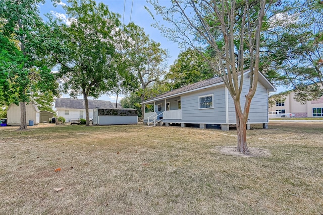 rear view of property featuring a lawn