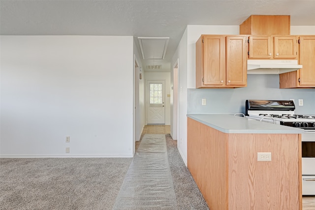 kitchen featuring light colored carpet, light brown cabinetry, and gas range gas stove