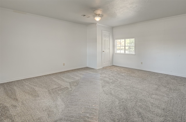 carpeted empty room featuring ceiling fan and ornamental molding