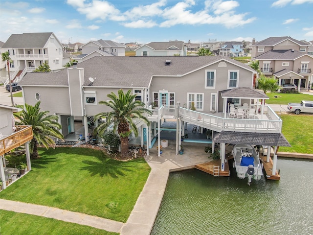 back of house featuring a wooden deck and a yard