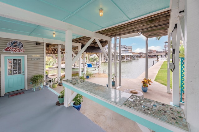 view of patio / terrace featuring a water view, a boat dock, and boat lift