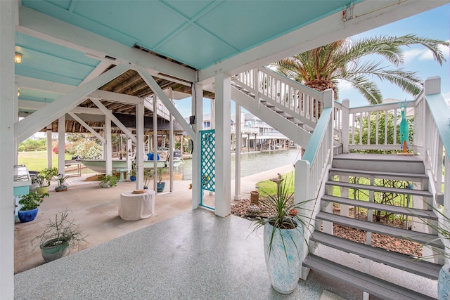 view of patio / terrace with a water view and stairway