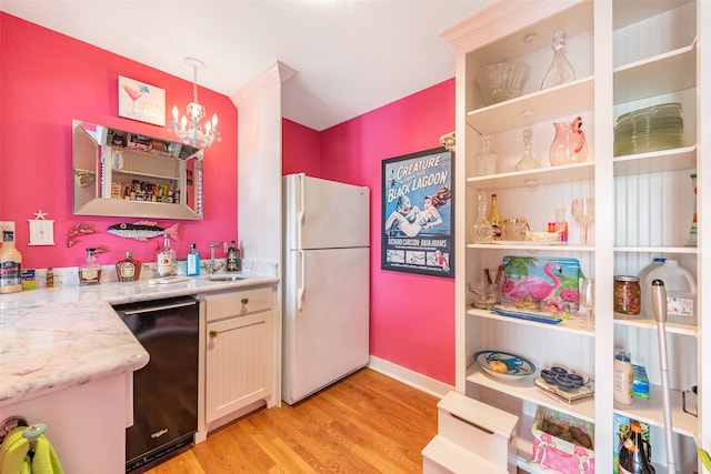 kitchen featuring dishwasher, freestanding refrigerator, light wood-type flooring, a chandelier, and pendant lighting