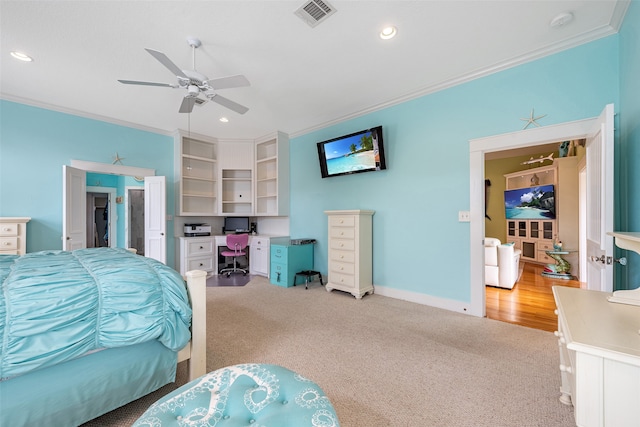 bedroom with ornamental molding, visible vents, and light colored carpet