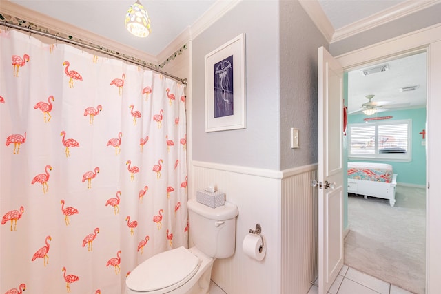 ensuite bathroom with visible vents, connected bathroom, toilet, a wainscoted wall, and ornamental molding