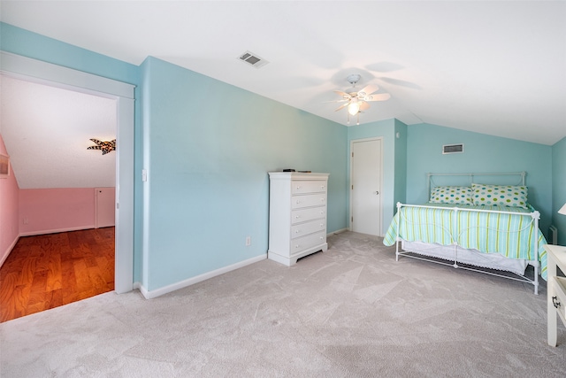 unfurnished bedroom with lofted ceiling, visible vents, ceiling fan, and carpet flooring