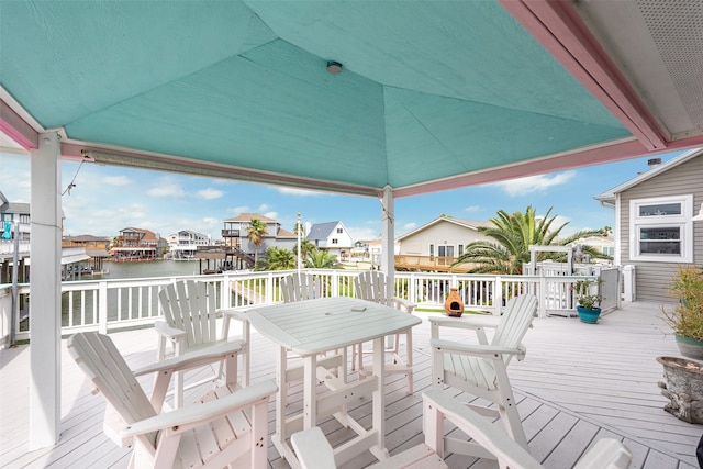 deck featuring a residential view and a water view