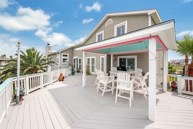 wooden terrace with outdoor dining area