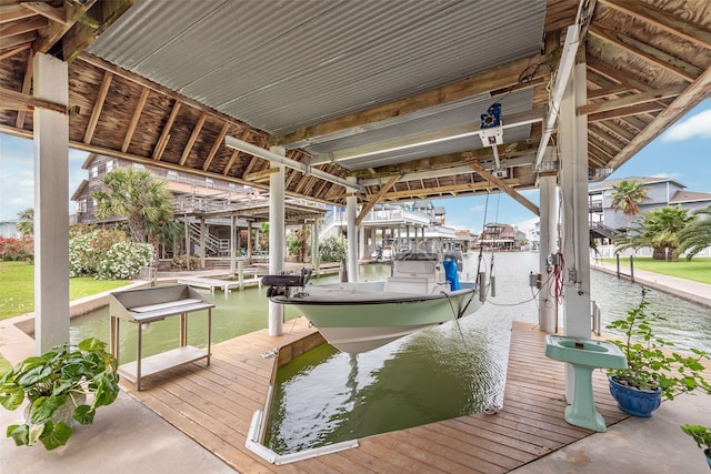 dock area with a water view and boat lift