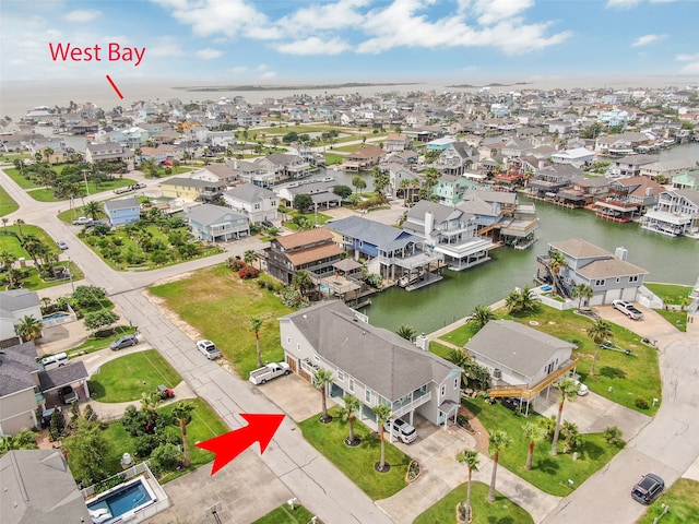 drone / aerial view with a water view and a residential view