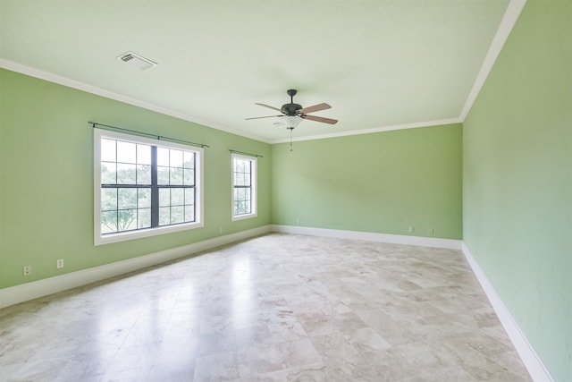 spare room featuring ceiling fan, ornamental molding, and light tile patterned floors