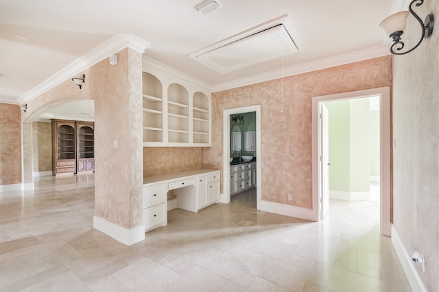 kitchen featuring crown molding, white cabinetry, built in desk, and light tile patterned floors