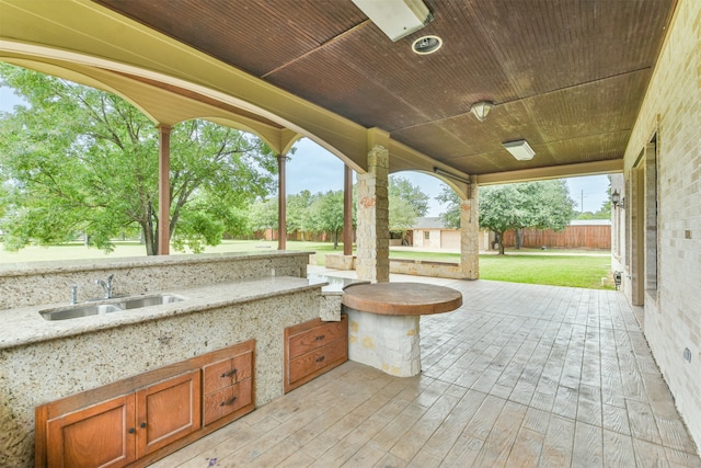 view of patio / terrace featuring sink and a wooden deck