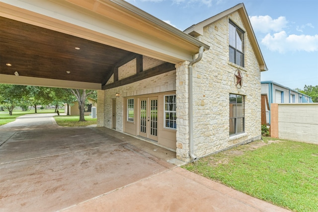 view of home's exterior with french doors, a yard, and a patio area