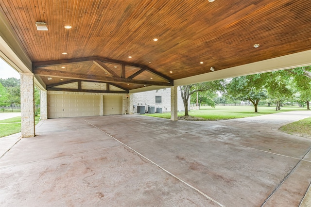 view of patio with cooling unit and a garage