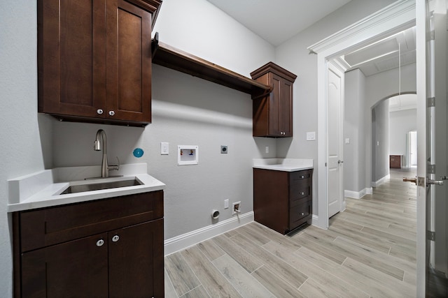 clothes washing area with gas dryer hookup, cabinets, sink, washer hookup, and hookup for an electric dryer