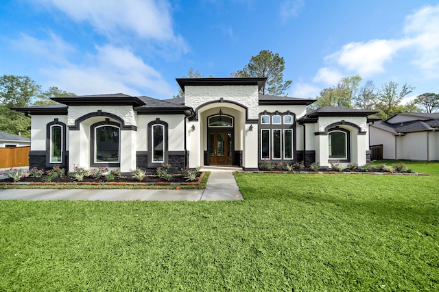 mediterranean / spanish-style house featuring a front yard