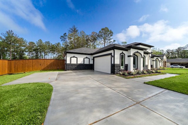 view of front facade with a front yard and a garage