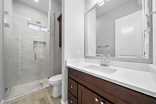 bathroom featuring vanity, toilet, and walk in shower