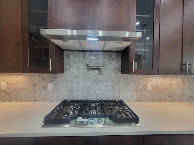 kitchen featuring dark brown cabinets, stainless steel gas cooktop, and tasteful backsplash