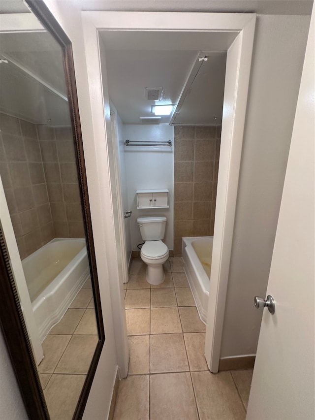 bathroom featuring tile walls, shower / bathing tub combination, tile floors, and toilet