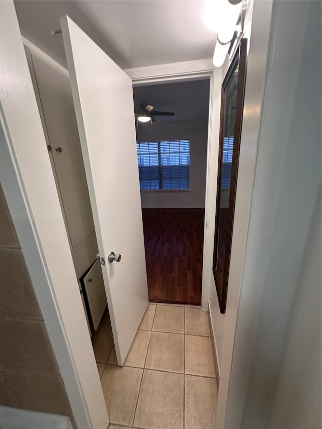 hall featuring light tile flooring