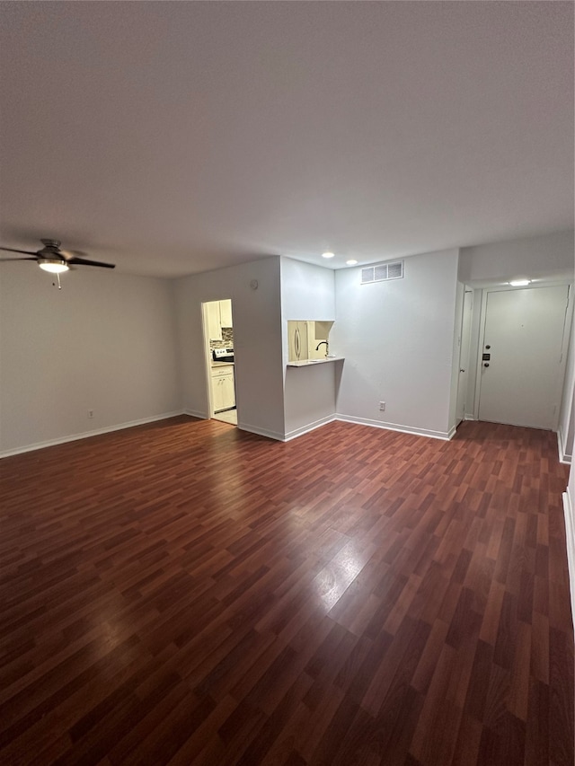 interior space with dark hardwood / wood-style flooring and ceiling fan