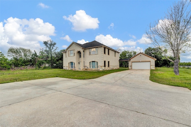 view of front facade with a garage, a front lawn, and an outdoor structure